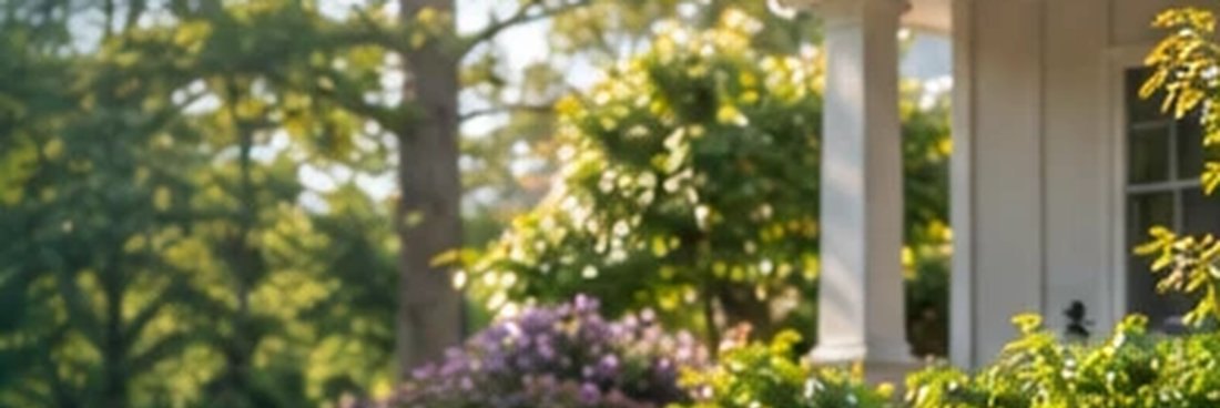 Flowering shrubs and mature trees in front of a home